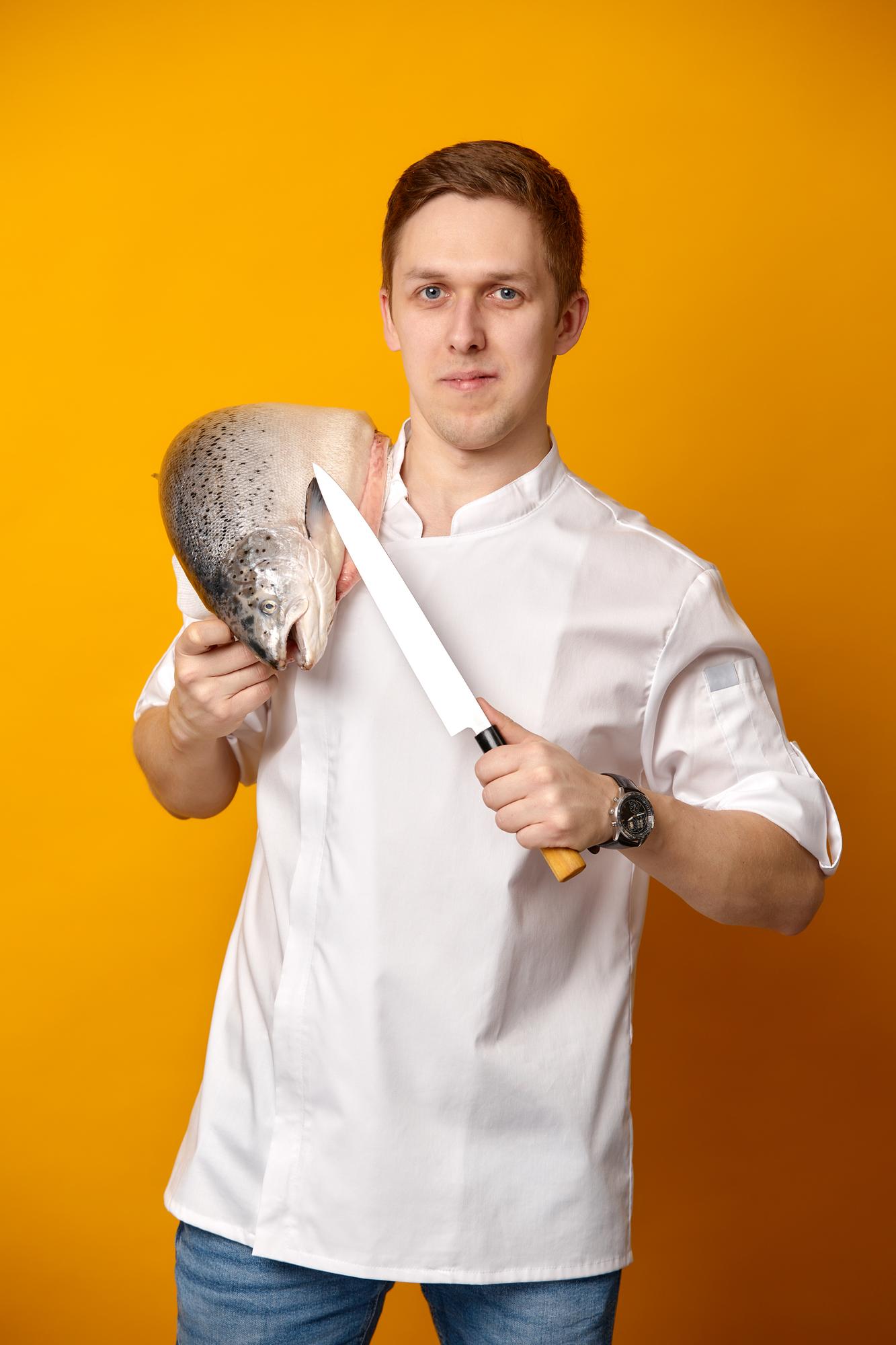 Student searing fish in workshop